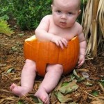 funny baby in pumpkin